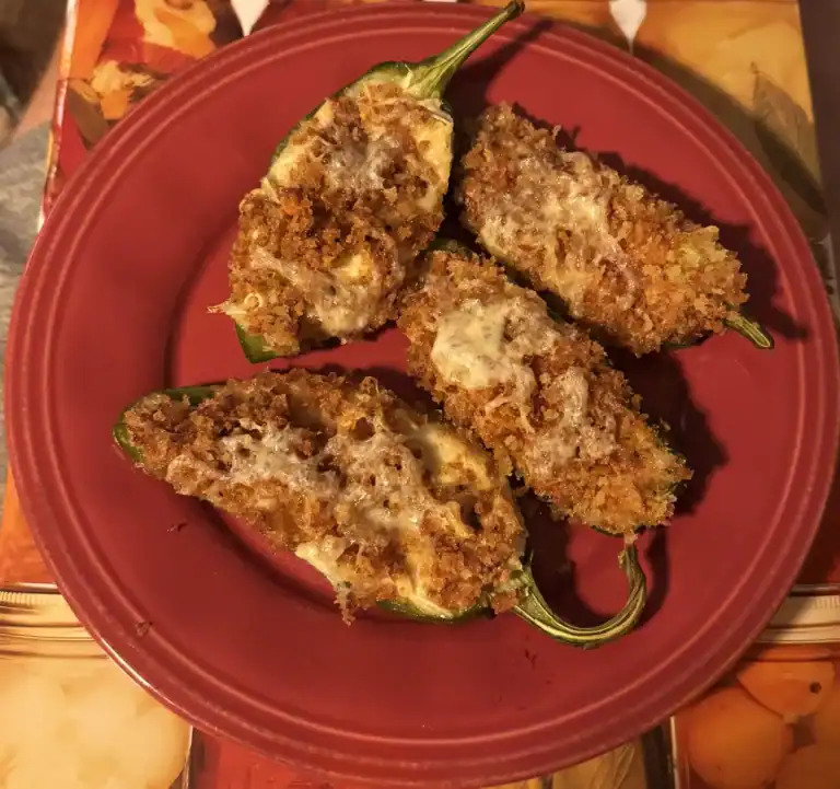 Garden-fresh baked jalapeño poppers stuffed with cream cheese and bacon, topped with golden panko breadcrumbs.
